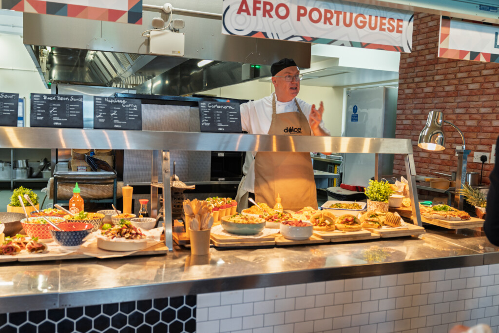 Dolce schools catering development chef at a high school service counter